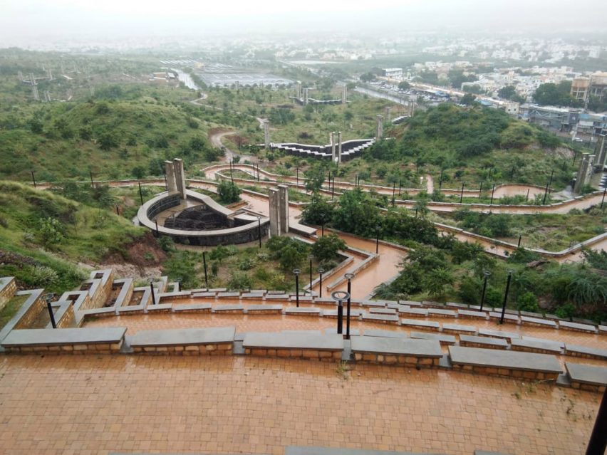 A hilly landscape with a fort wall and walkway meandering through