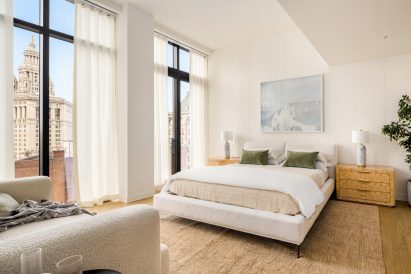 Neutral-toned bedroom with tall ceilings