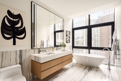 Bathroom featuring richly veined book-matched Montclair Danby marble