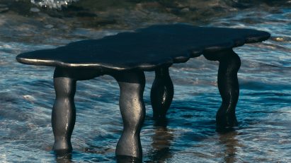 Photo of a black aluminium table by Ferm Living and Anna Maria Øfstedal Eng in water