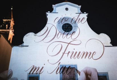 Wall of a building with calligraphy projected onto it