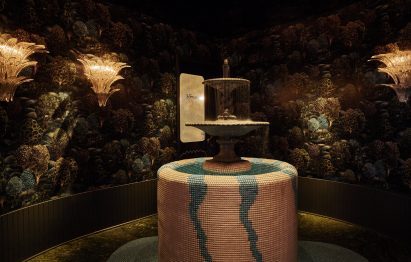 Dark room with a classical-style fountain at the centre