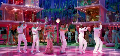 Barbie movie cast dancing in a pink town square