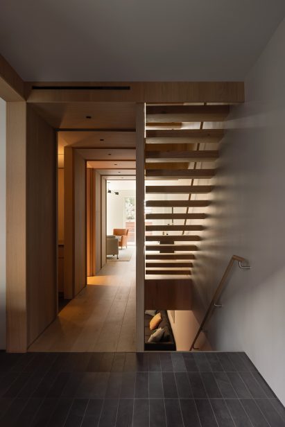 Dimly lit hallway with staircases to the right
