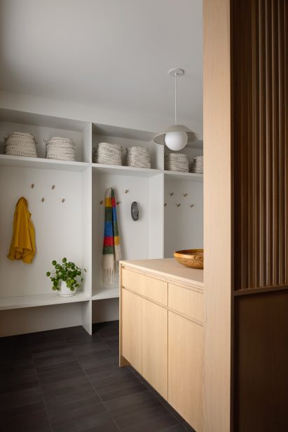 Minimal mud room with oak cabinets and slate flooring