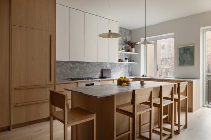 Kitchen featuring oak millwork and grey stone counters