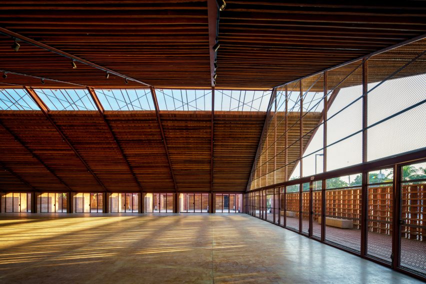 An expansive interior space with a large pitched timber roof and glazed gable end