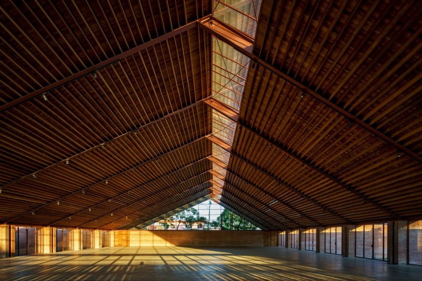 A large interior space with a pitched timber roof and glazed gable end