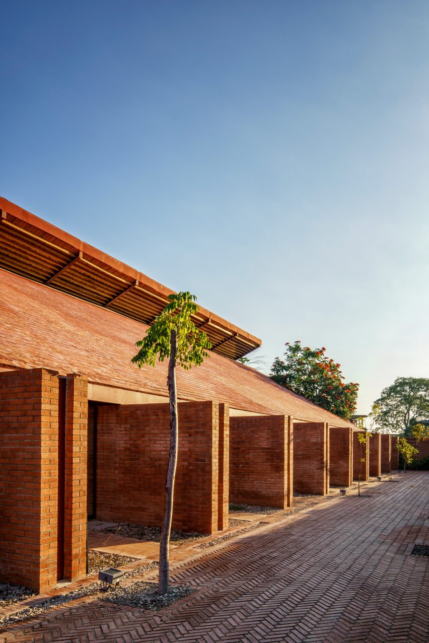 Double brick walls in a row along a boulevard supporting a sloped roof
