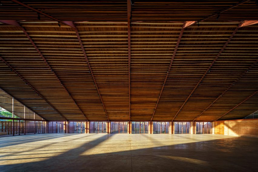 A large interior space with a pitched timber roof and glazed walls
