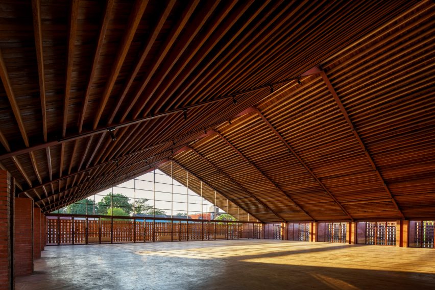 A large interior space with a pitched timber roof and glazed gable end