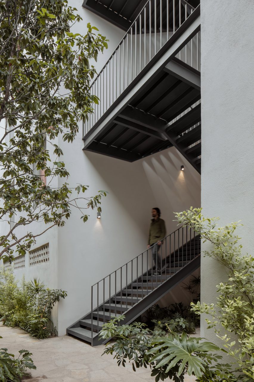 Black metal staircase in a white apartment building
