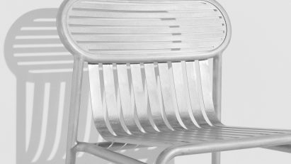 Shiny silver garden chair on white background