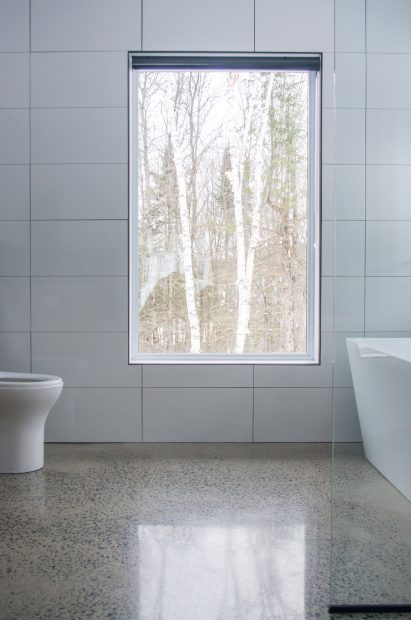 Bathroom with white walls and concrete floors