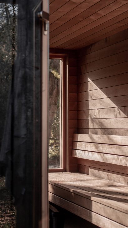 Interior of wooden sauna by Out of the Valley