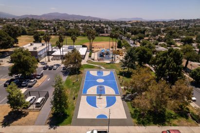 Sports field with solar-reflective coating