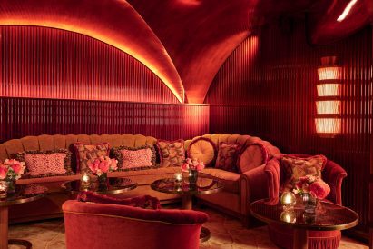 red sofas and polished wood panel work
