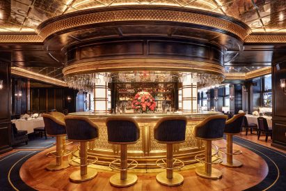 circular bar with metal latticework and high bar stools