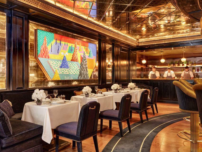 dining room with artwork metalwork and mirrored glass