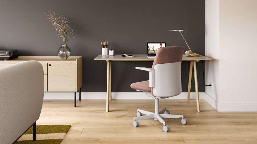 Pink fabric upholstered Path office chair by Humanscale at a desk in a living room with wooden floors