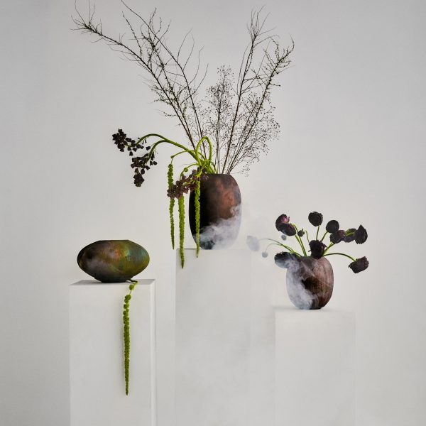 Ceramic vases on white pedestals with mist