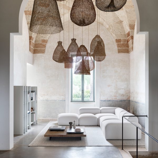 Living space with white sofa and basket lights hanging above