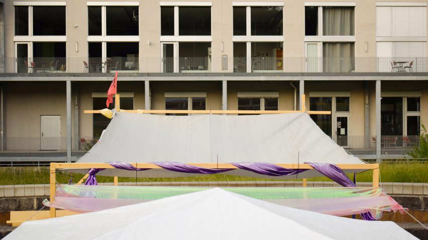 Photograph showing tent-like covering attached to building facade