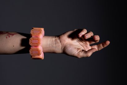 A pink bracelet made of packaging foam shaped into jewel shapes