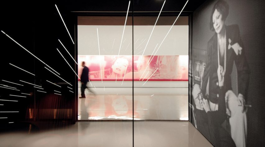 Gallery space with black walls and large windows at the Hammer Museum