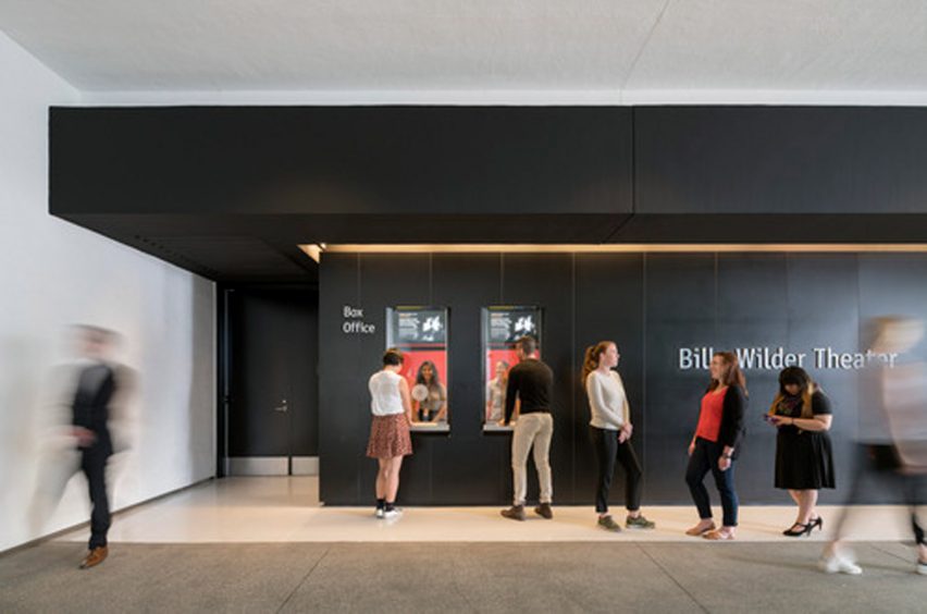 Theatre box office with black walls and wooden floors at the Hammer Museum