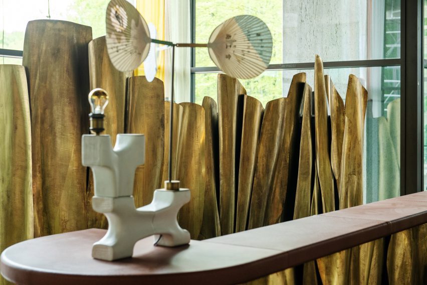 hotel lobby featuring reception desk by Maison Jonckers and lamp by Lionel Jadot