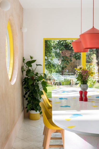 Colourful kitchen with ivy plant and island
