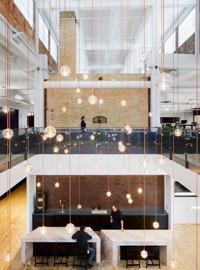 Atrium filled with glass globe lights suspended on individual wires