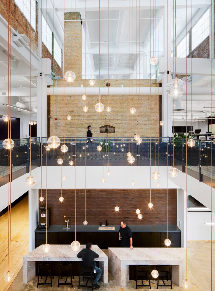 Atrium filled with glass globe lights suspended on individual wires