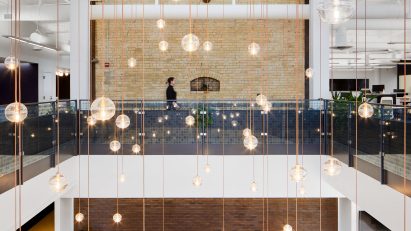 Atrium filled with glass globe lights suspended on individual wires