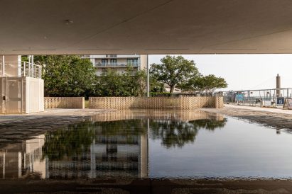 Water feature with perforated brick wall in the background