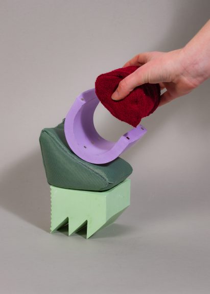 Hand touching objects on grey background