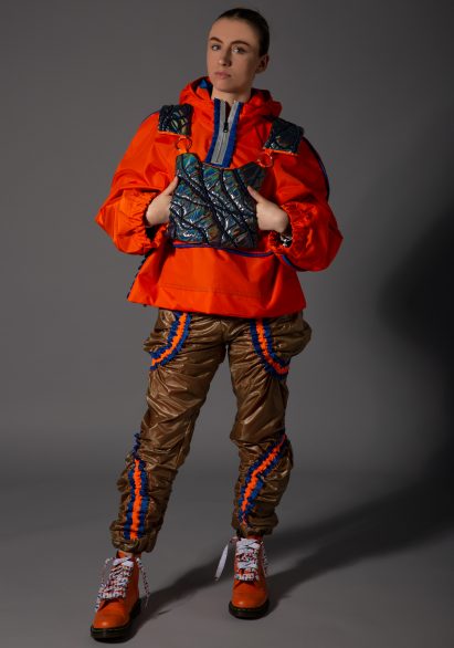 Model wearing outdoor-style clothing on black backdrop
