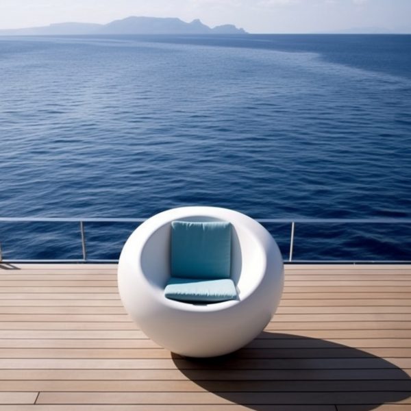 Spherical white lounge chair on a wooden deck on a boat at sea