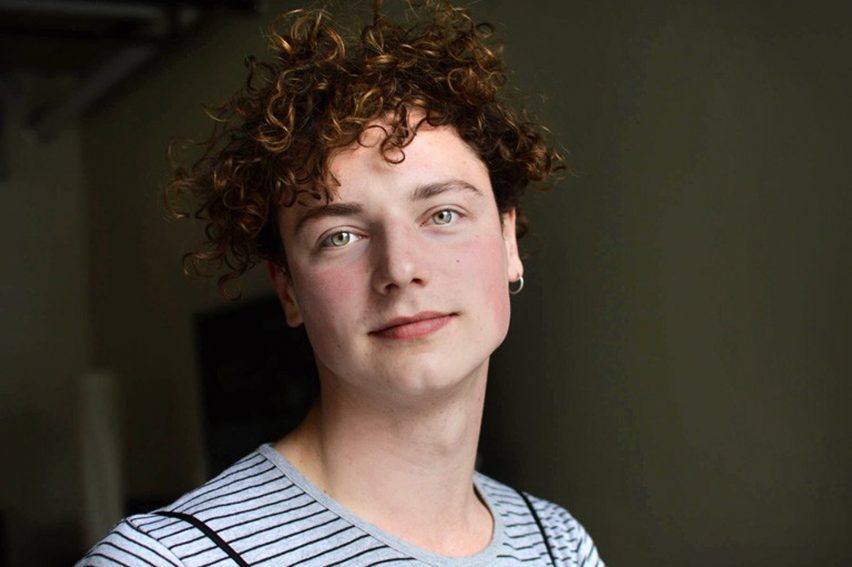 Photo of designer Lucas LaRochelle with curly brown hair and a blue and white striped top