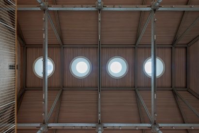 Wood-lined ceiling punctured by skylights