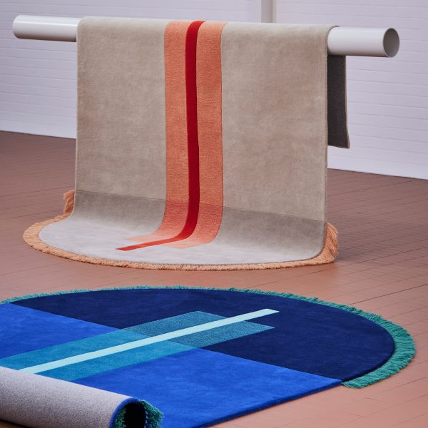 Two round-edged rugs in showroom