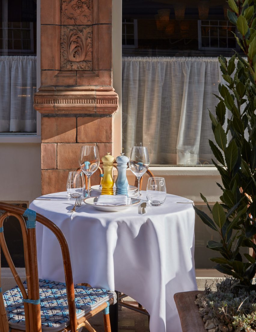 Circular table outside a restaurant with terracotta-tiled walls