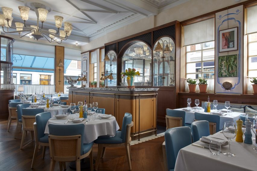Socca restaurant interior with wood wall panelling and a marble bar
