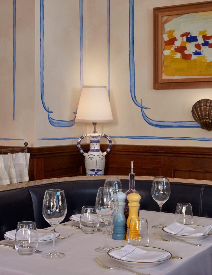 Booth seating at a restaurant with hand-painted wall murals