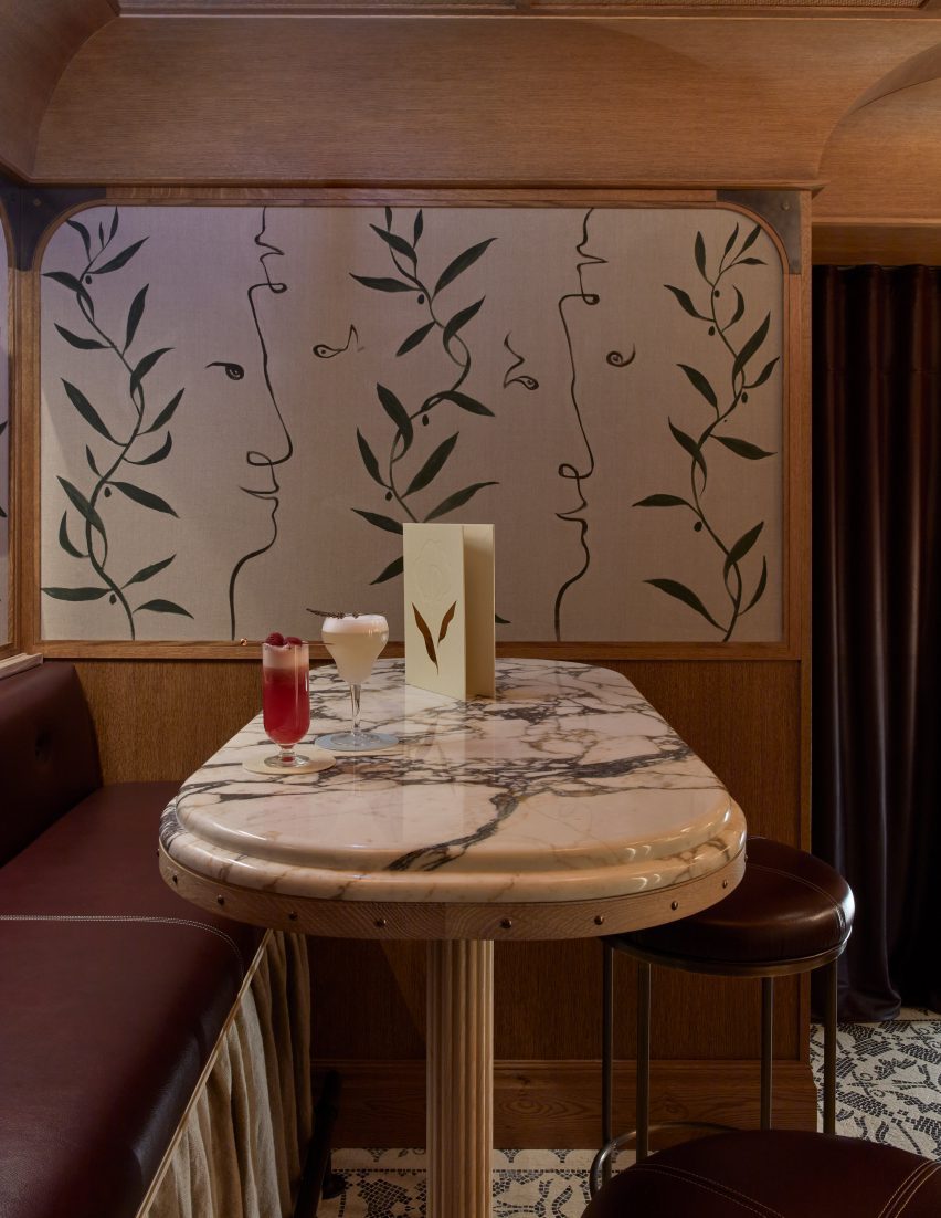 Bar stools at a marble table at Socca restaurant