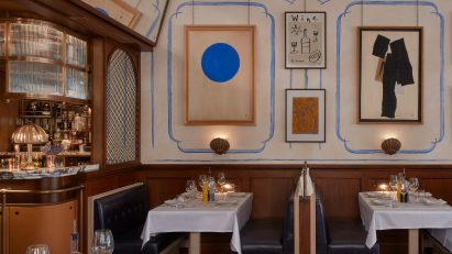 French-style Socca restaurant in London with wood panelling and hand-painted murals