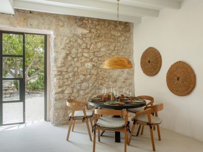 Exposed stone wall in hotel in Mallorca by Único Hotels and interior designer Pilar García-Nieto