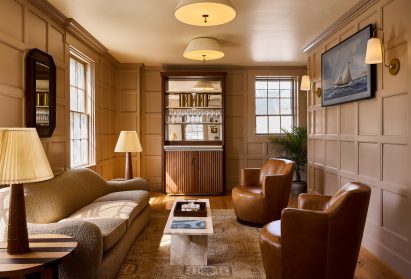 Earth-toned private lounge with leather and bouclé seating