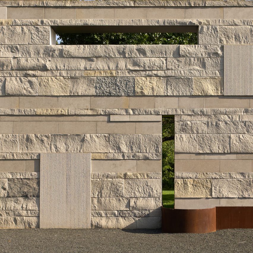 A stone-like wall with rectangular perforations at Casa Escuda by Tobin Smith Architect